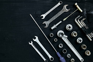 Set of hand bunch of tools in the garage on black wooden background