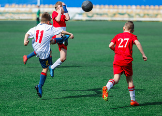 kids play football tournament and enjoy their game on the stadium