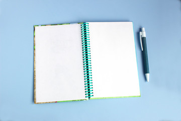 Blank paper notebook on blue background