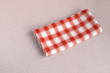 Red checked tablecloth on beige background