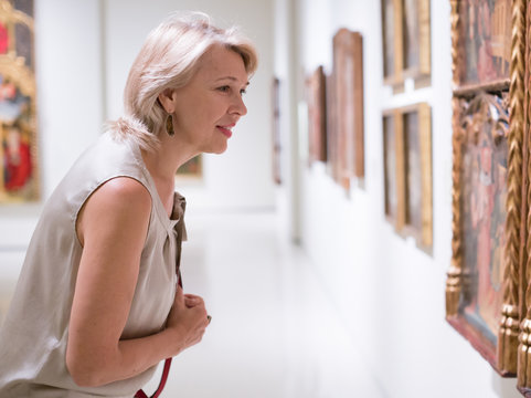 Female visitor looking at artwork painting