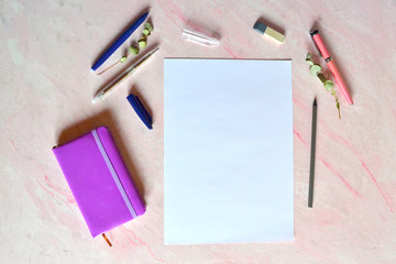 White sheet of paper, pens, pencil, nonebook on the desk. Workspace for art. Place for painting.