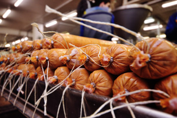 Smoked sausage in the oven. Sausage production in the factory.