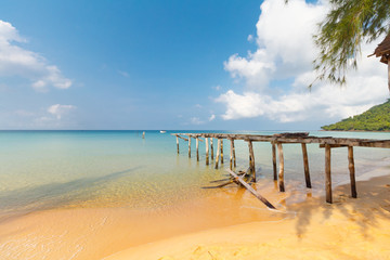 damaged pier at sunset beach on Koh Rong Samloem, Cambodia, turquiose water, paradise