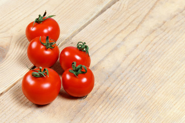 ripe red tomatoes on a wooden table