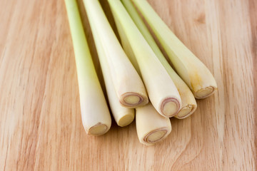Lemongrass close-up on a wooden table. Fresh stems of lemongrass on a wooden surface.