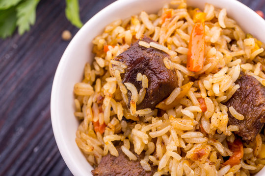 Meat pieces in pilaf with rice and carrot
