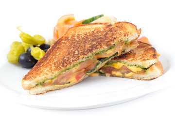 pesto tomato grilled cheese sandwich on white background