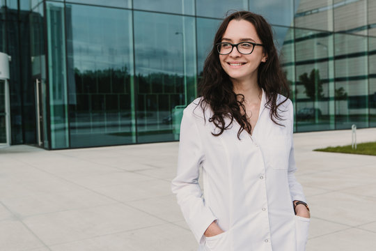 Woman in whites at modern building