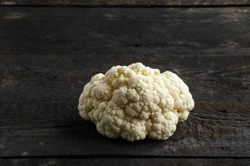 Fresh cauliflower on dark vintage wooden background
