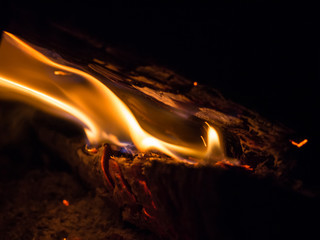Burning woodfire in a fireplace on a black background