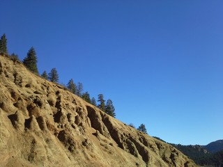 Rocky, Brown, Eroded Slope on a Blue Sky in Colorado
