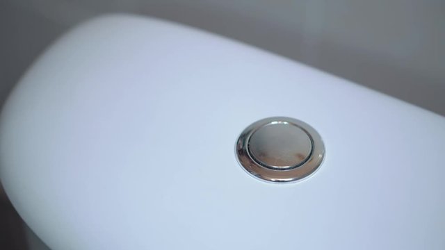 Female finger on a double toilet wash. Flush toilet, handle for toilet handles. 4k video.