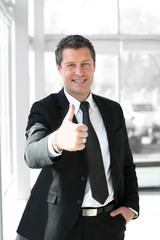 successful businessman showing thumb up