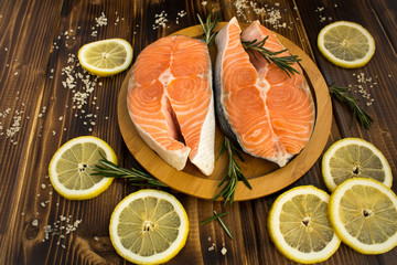 Salmon fillets on the round wooden cutting board