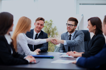Two professional business people shaking hands.