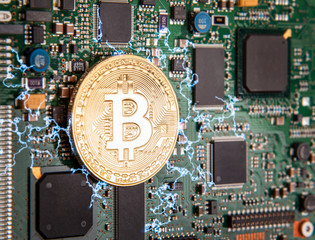 gold coin bitcoin on a green board with microchips