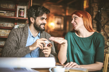 Young colleagues working together at cafe.