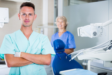 Fototapeta premium Male dentist in dental office with hands crossed