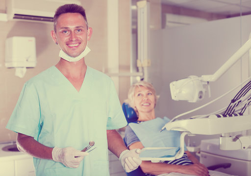 Male dentist standing in dental office