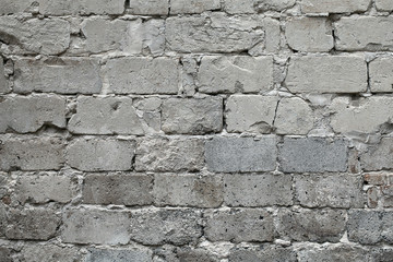 Old broken gray brick wall background. Old gray damaged brick wall texture, Gray brick backdrop and texture for text or image. Gray background for design, design and template.