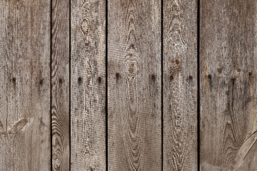 Old wood plank with steel sinker nails texture background. The texture of old wood. Vertical wooden planks. Wooden fence backdrop.