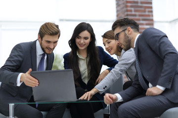 Beautiful business people are using a laptop during the conferen