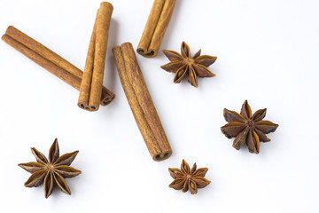 Spices: star anise and cinnamon sticks on white background. Close up.