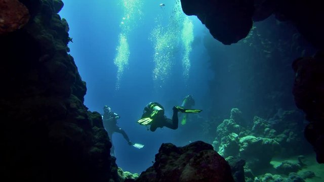 cave diving underwater scuba divers exploring cave dive