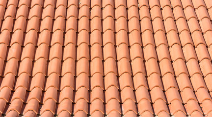 Texture of orange roof tiles of a new roof