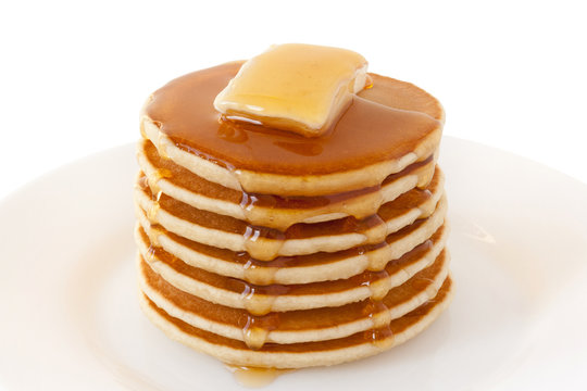 Pancakes Stack with Butter and Maple Syrup isolated on a white background. Shrove Tuesday. Mardi Gras. Pancakes Day. Food. Family Breakfast. Brunch. Dessert. Snacks. Sweets.