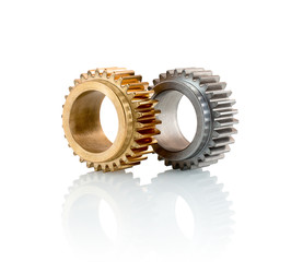 Sets of gears, cogwheels made of steel and brass isolated on white background with shadow reflection. Spur gears isolated on white background with shadow reflection.