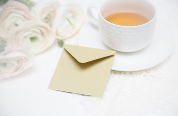 Bouquet of flowers with cup of tea and love letter. Invitation card. Valentines day card.