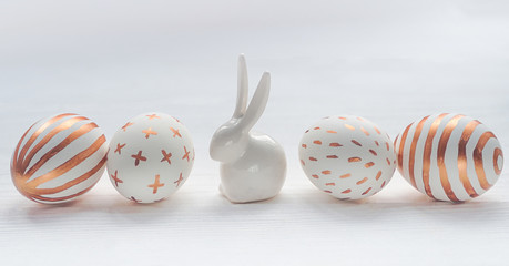 Golden Easter eggs row on wooden rustic vintage background.