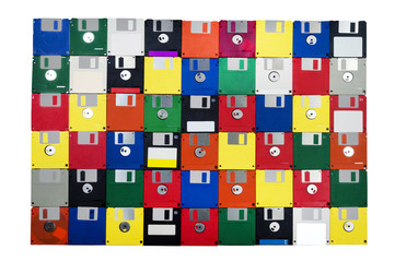 Horizontal shot of a group of multicolored plastic diskettes laid in a solid background with a...