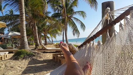Tropical exotic beach girl in swing on ocean sand beach under the palm trees holliday travel concept