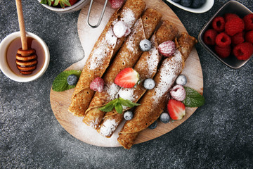 Delicious Tasty Homemade crepes or pancakes with raspberries and blueberries