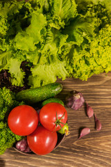 Food ingredients. Fresh vegetables in a wooden bowl. Background of vegetables.