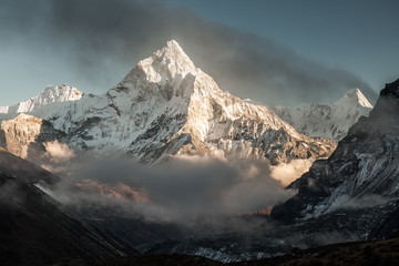 Ama Dablam mountain. Sun illuminates slopes. Himalayan mountains, Nepal. - obrazy, fototapety, plakaty