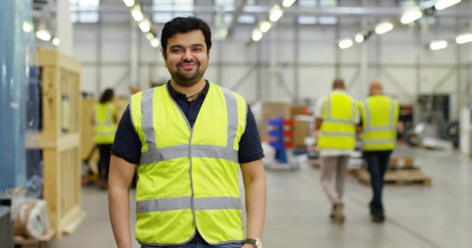 4k, Portrait of a cheerful and friendly male warehouse manager. Slow motion.