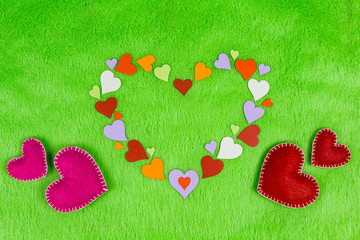 colored paper hearts on a green cloth