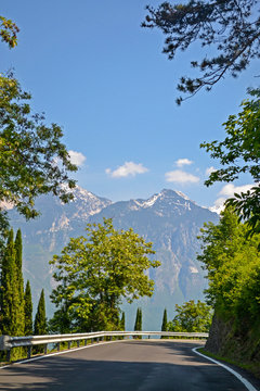 Winding road with mountains view of the Alps, on Strada della Forra driving road, Lake Garda, Northern Italy