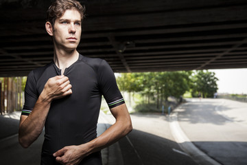cyclist in black climbing the cream of the jersey in tunnel