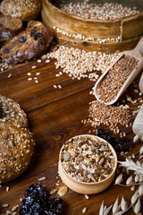 Assortment of baked bread on wooden table background