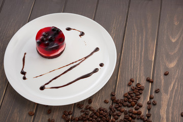 jelly cake with currant on a biscuit on a white plate