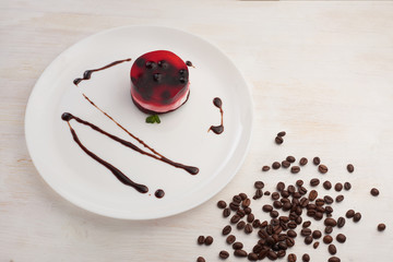 jelly cake with currant on a biscuit on a white plate