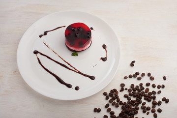 jelly cake with currant on a biscuit on a white plate