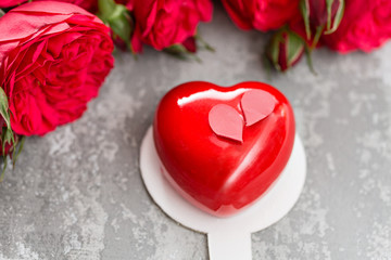 Naklejka na ściany i meble Valentines day or birthday greeting card. Cake in the form of a red heart. Red roses and dessert on vintage wooden table