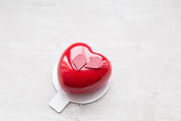 Valentines day or birthday greeting card. Desserts in the form of a red heart. The light from the...