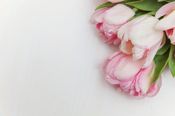 Bouquet of pink tulips over shabby white wooden table. Spring greeting card happy mother day copy space